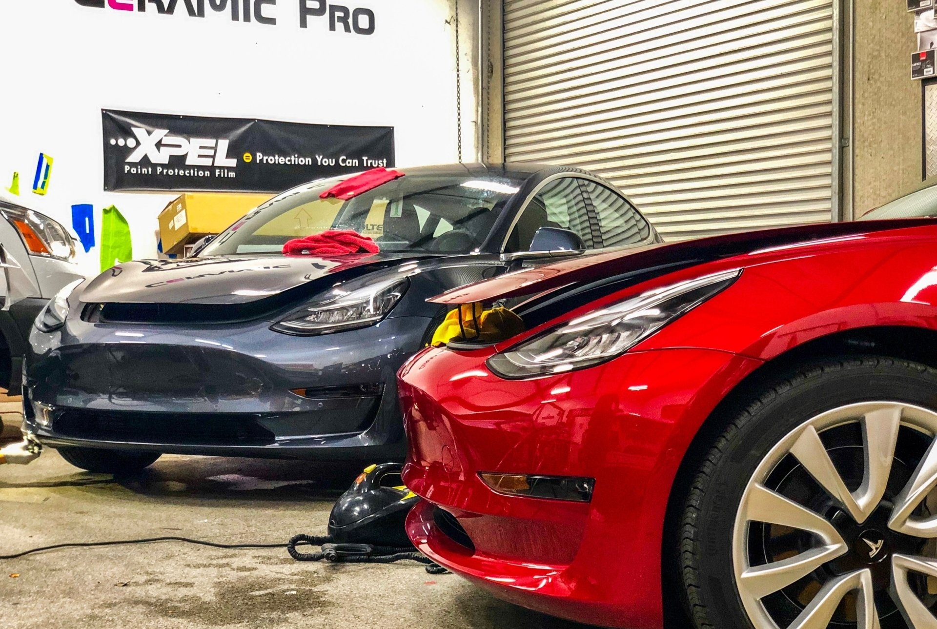 A row of cars are parked next to each other in a garage.