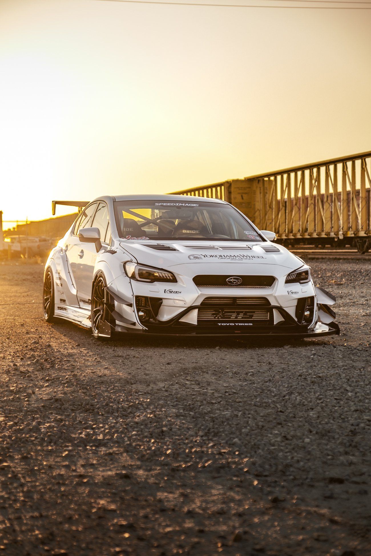 Subaru WRX — white Varis widebody STI show car (filename confirms vinyl wrap).