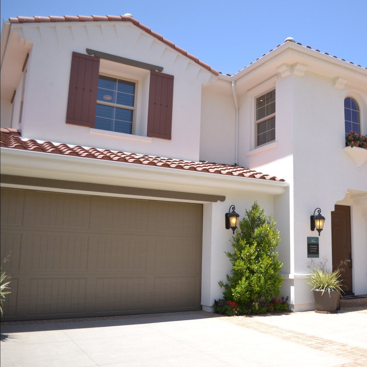 A white house with brown shutters on the windows