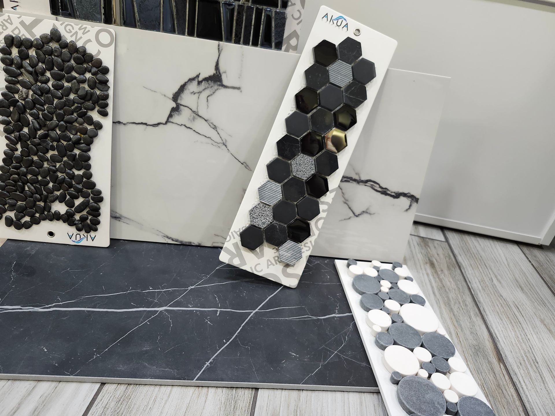 A person is holding a square tile in their hand.