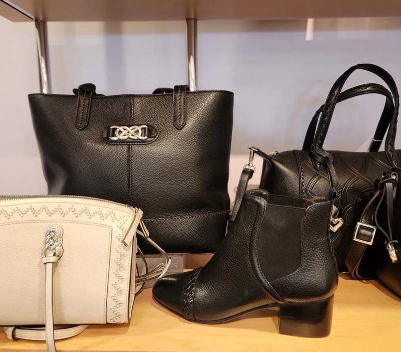 A collection of handbags and shoes on a shelf