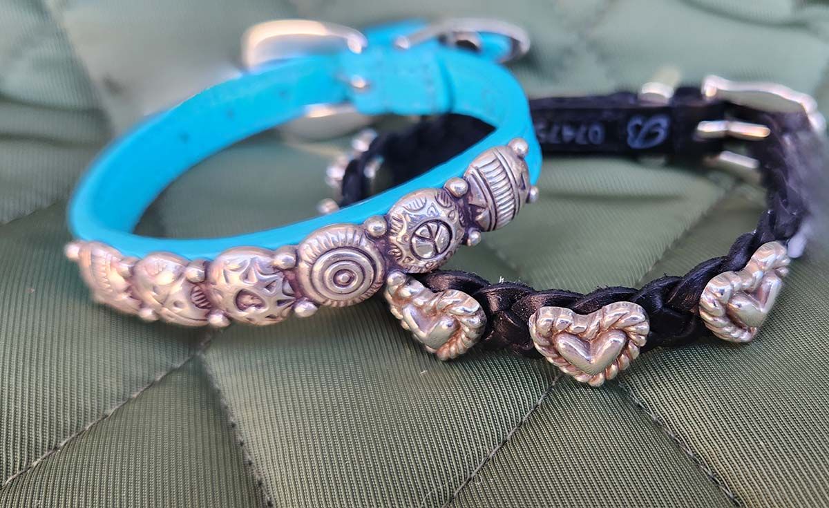 A blue and a black bracelet with hearts on them