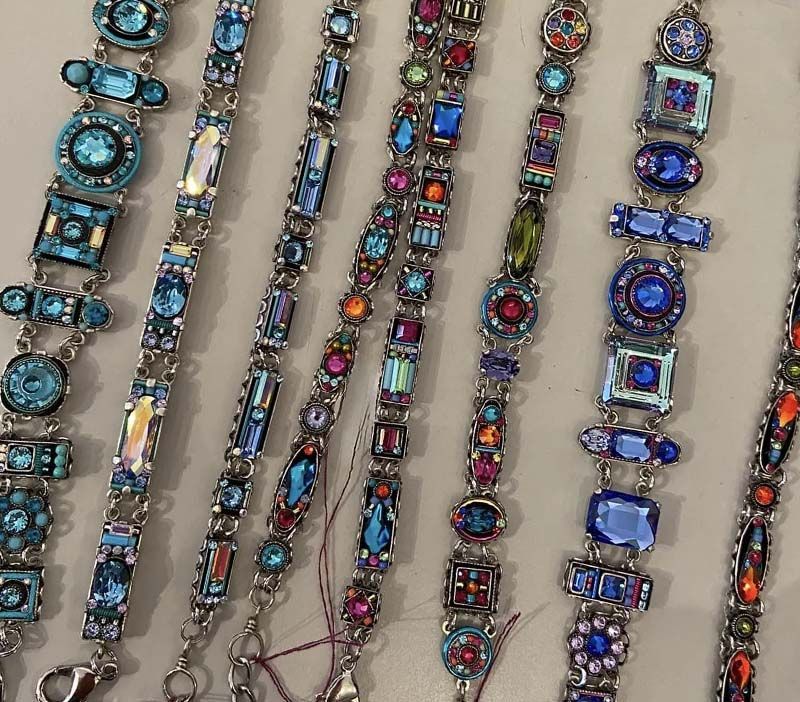 A bunch of bracelets are lined up on a table