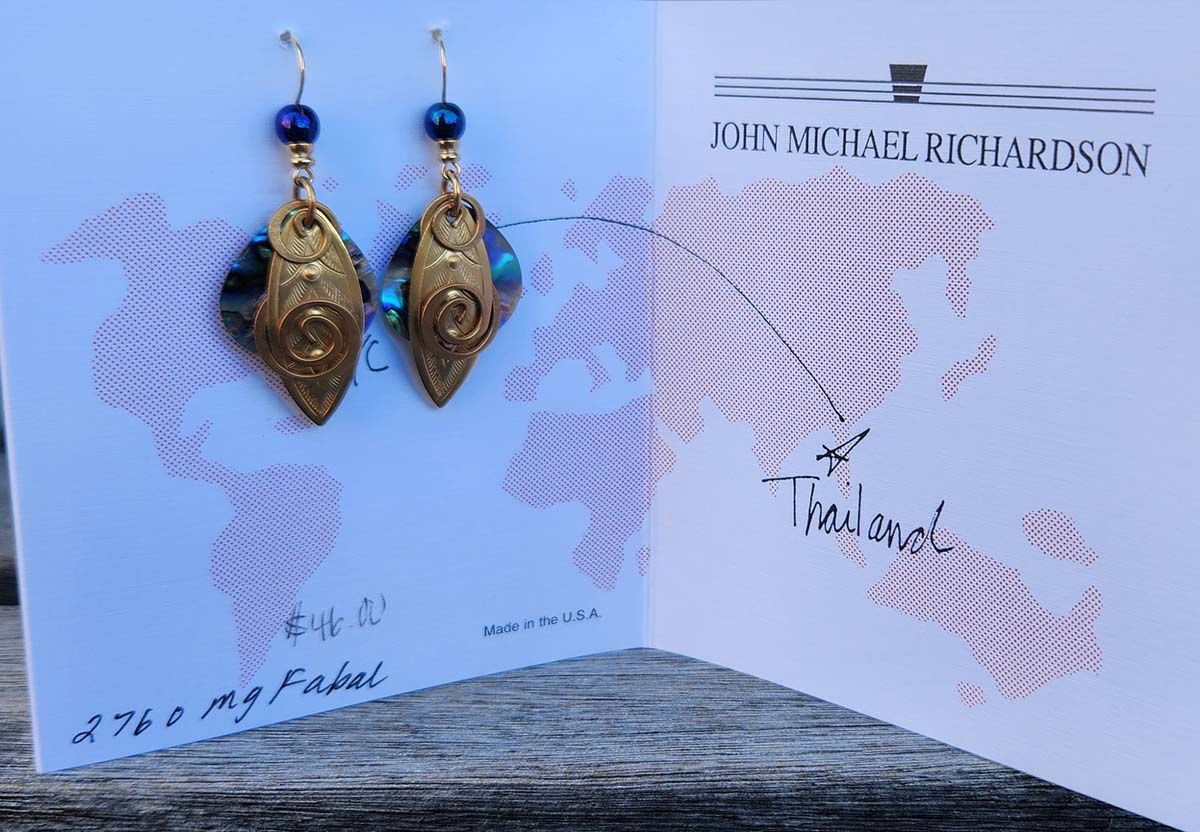 A pair of earrings on a card that says richardson