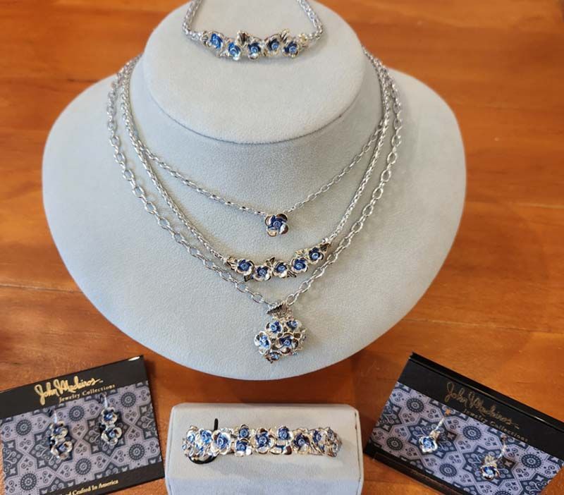 A necklace bracelet earrings and ring are on display on a mannequin