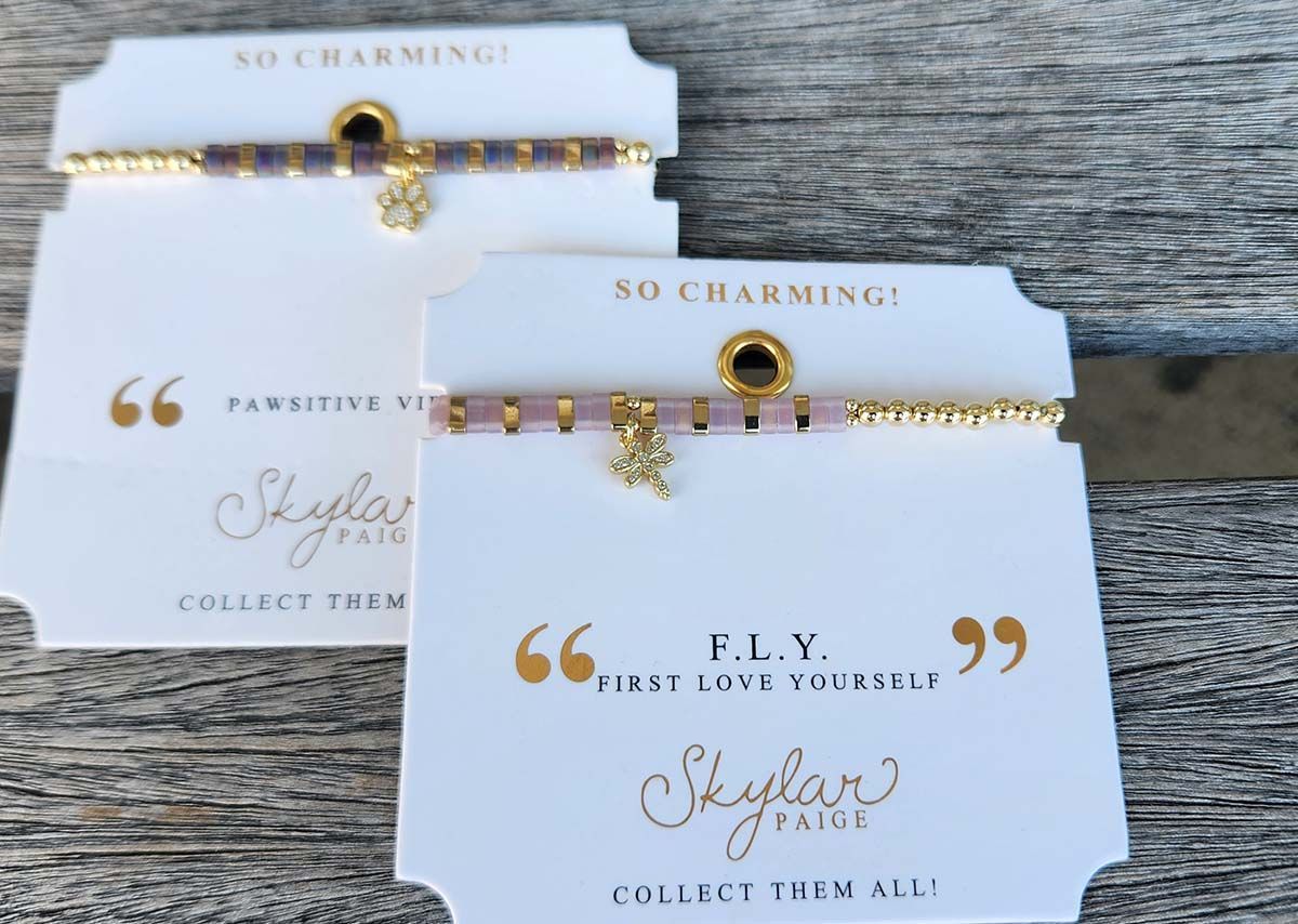 Two bracelets are on a card that says so charming