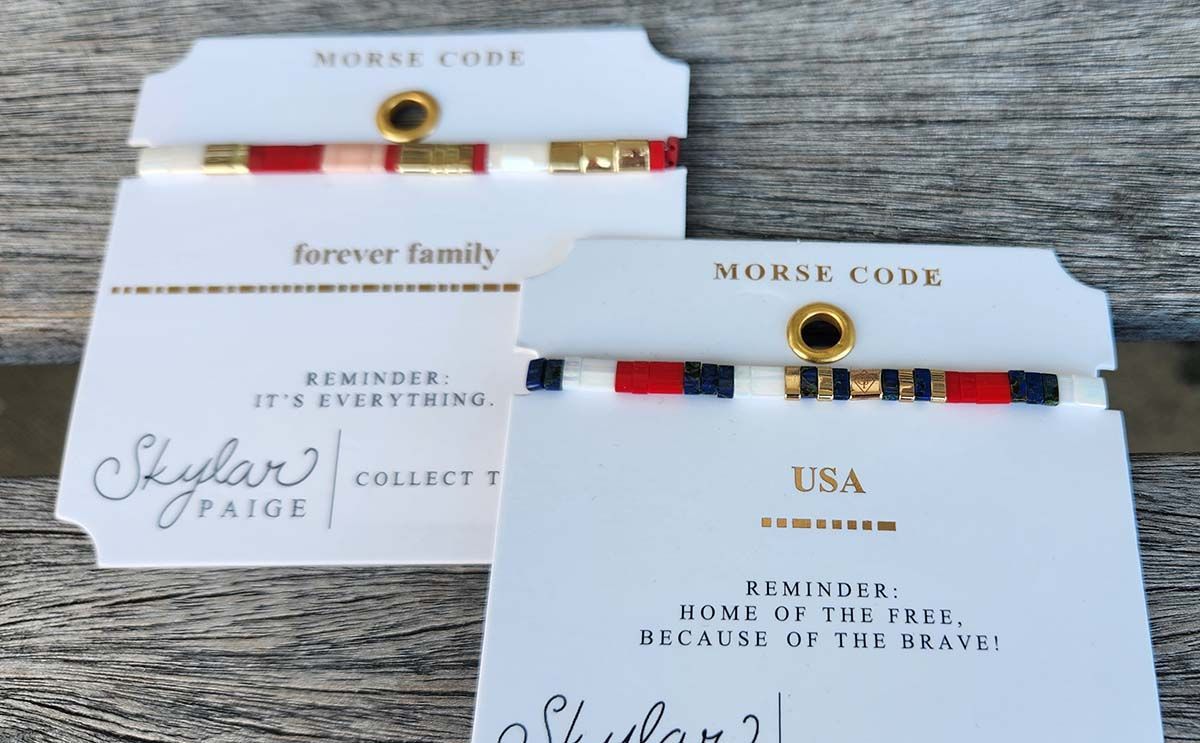 Three bracelets are sitting on a wooden table and one says forever family