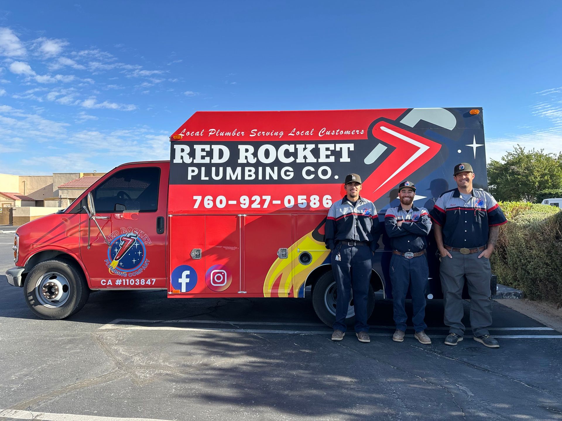 A red rocket plumbing company van is parked in a parking lot.