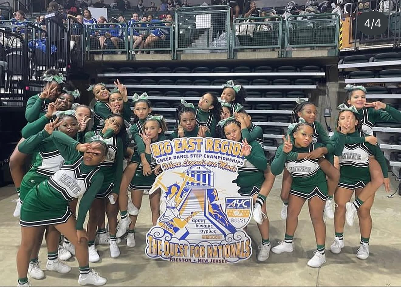 Red, white, and blue pom-poms held high by cheerleaders during a performance.