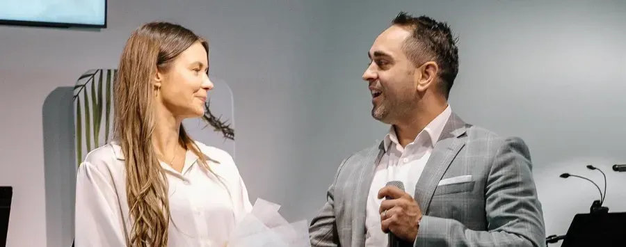 A man and a woman are talking to each other in a room.