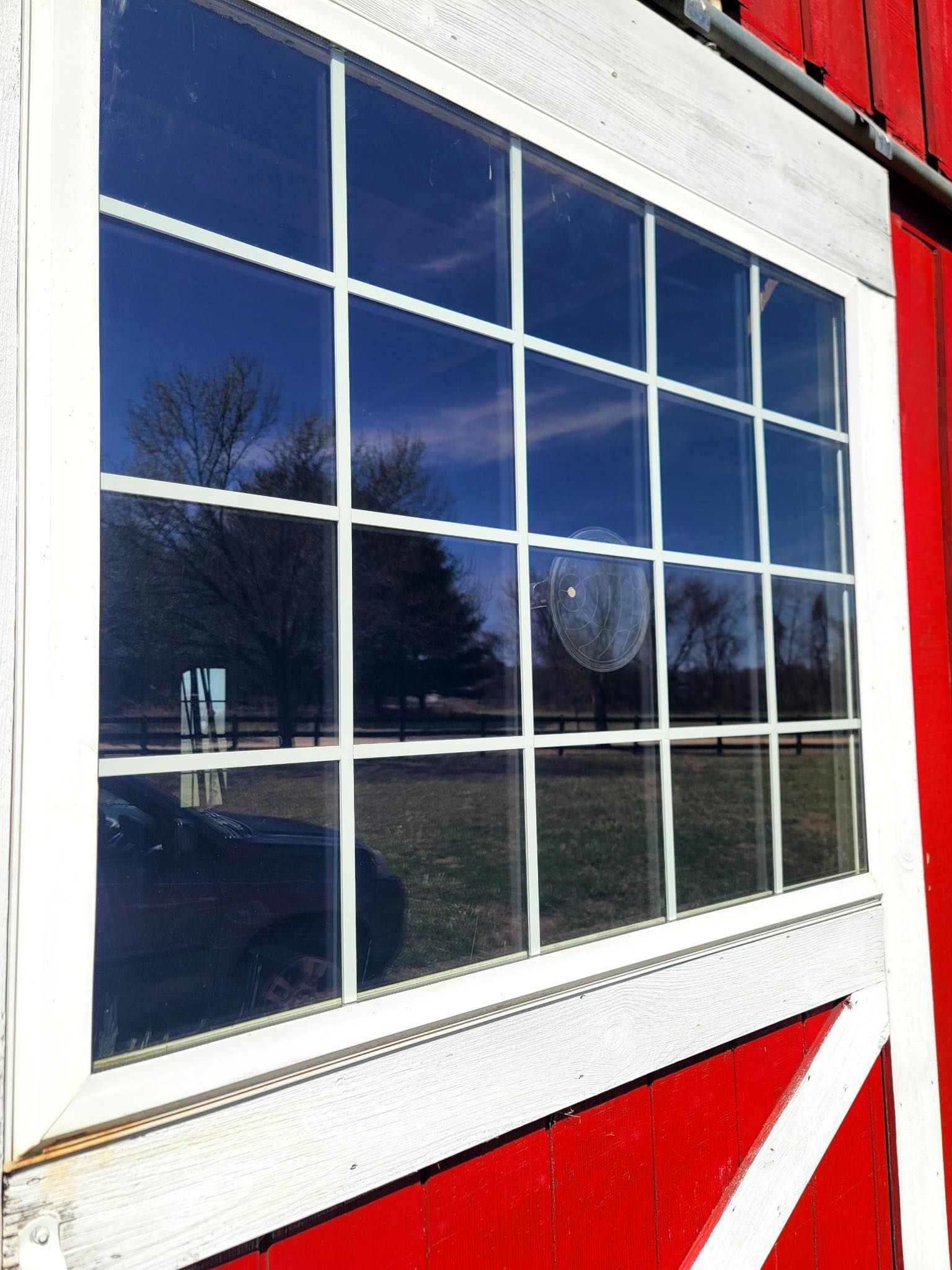 A red and white barn with a white window