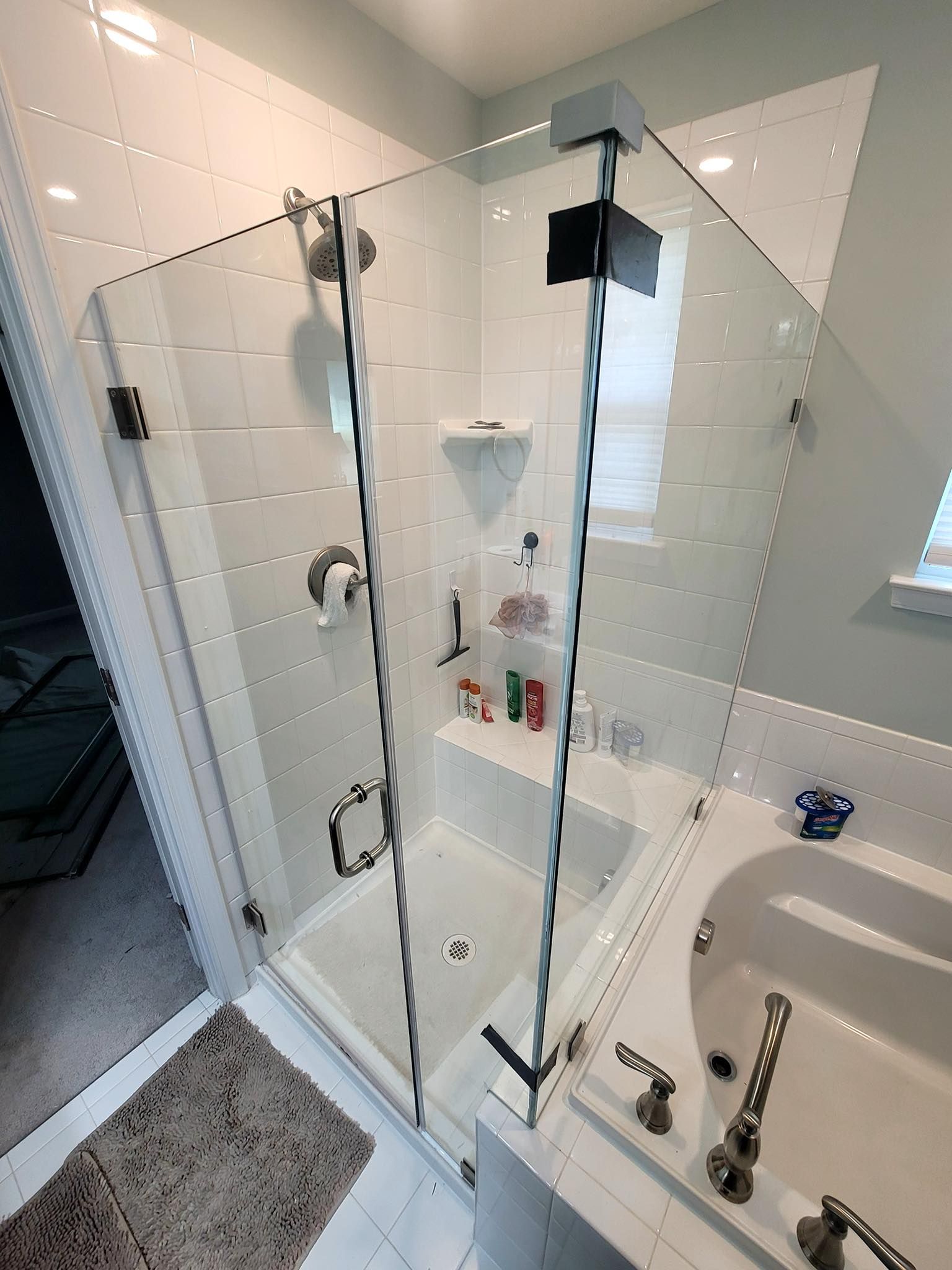 A bathroom with a walk in shower and a bathtub.
