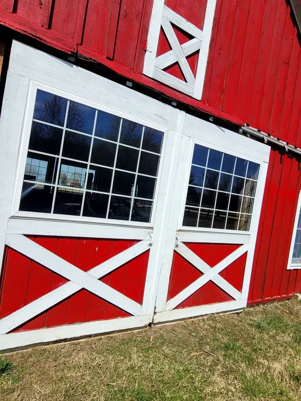 A red barn with white doors and windows