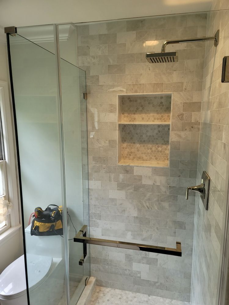 A bathroom with a walk in shower and a toilet.