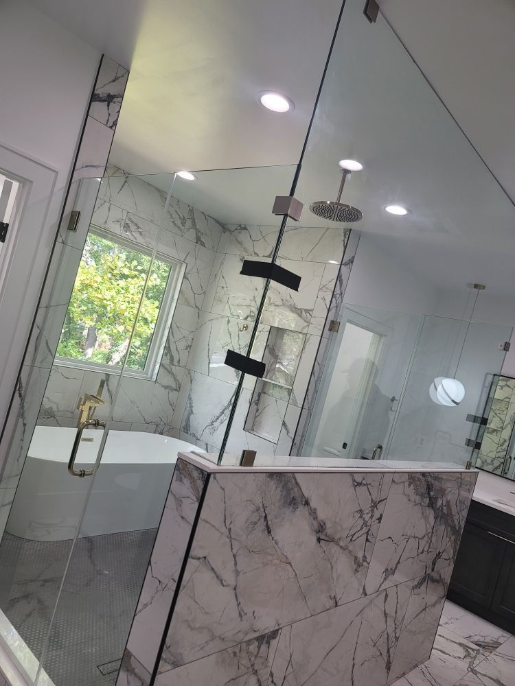 A bathroom with a walk in shower and a bathtub.