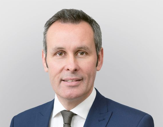 Silhouette of a person, likely male, in a suit jacket, head and shoulders.