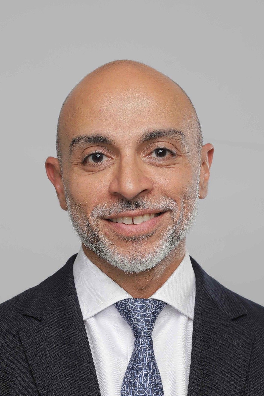 Silhouette of a person, likely male, in a suit jacket, head and shoulders.