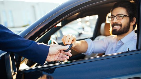 man giving car keys to valet