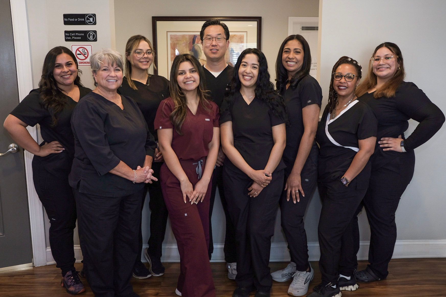 A group of women in scrubs are posing for a picture.