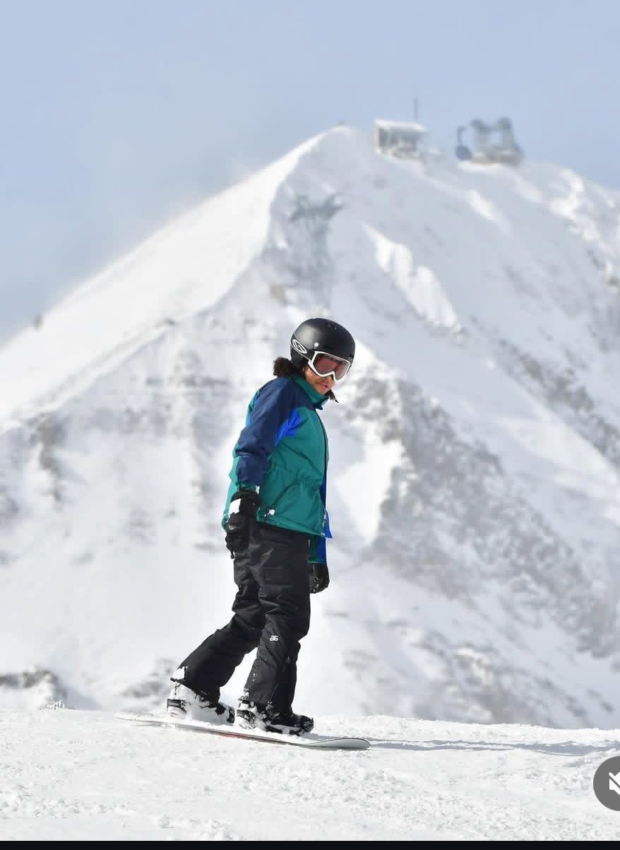 A patio with a lot of furniture and lights at night.