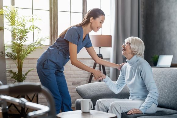 Caregiver assisting senior woman with mobility support at Clearstream