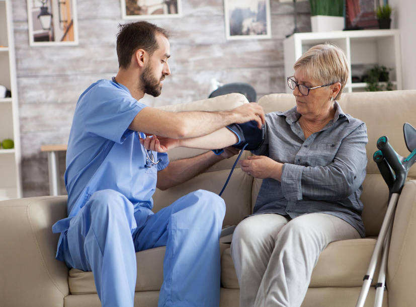 Caregiver assisting senior woman with daily health support