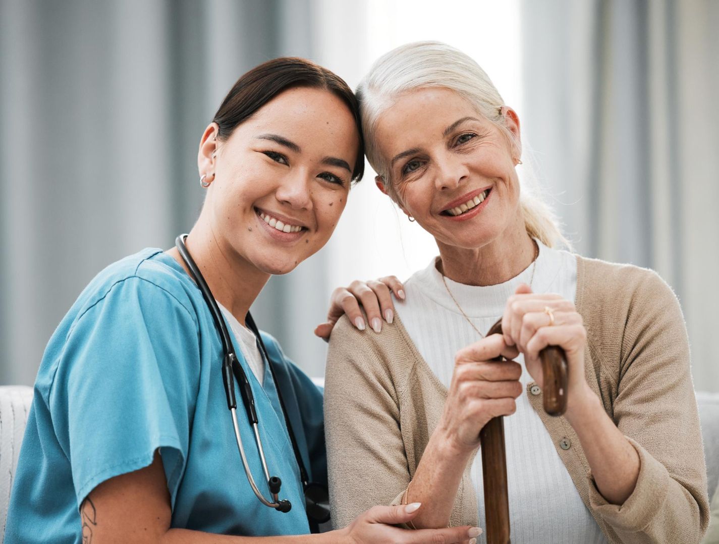 Caregiver and senior woman smiling side by side at Clearstream Rehab