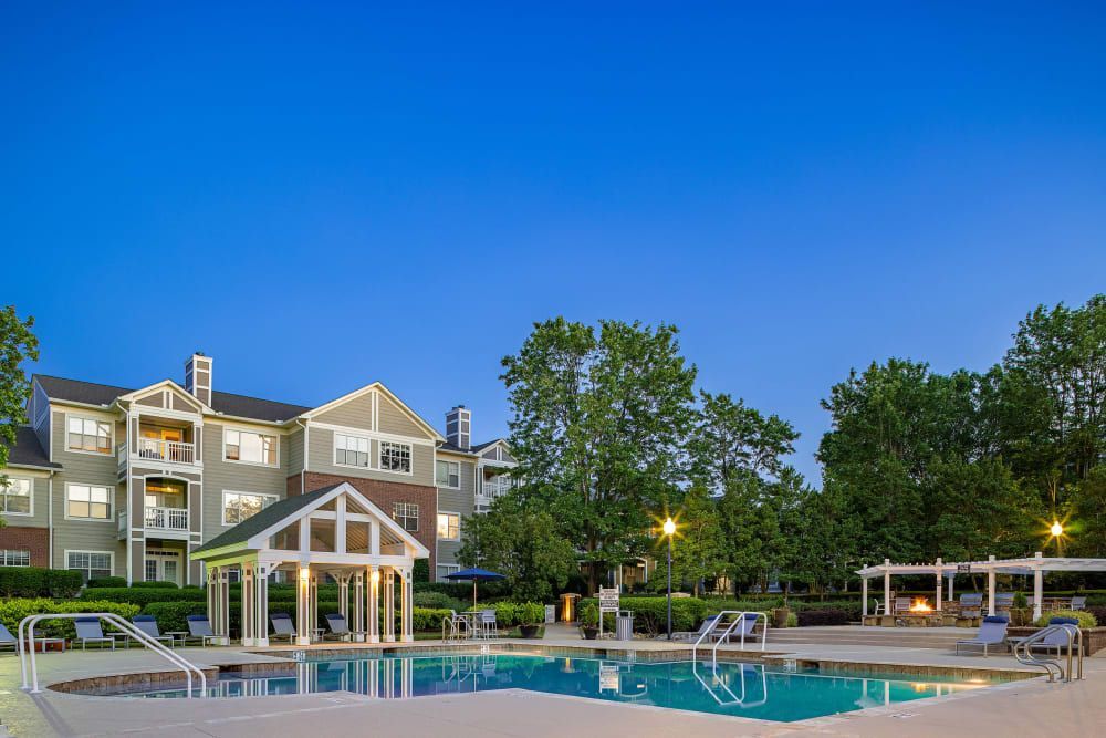 a large swimming pool in front of a large apartment building at The Preserve at Ballantyne Commons in Charlotte, NC.
