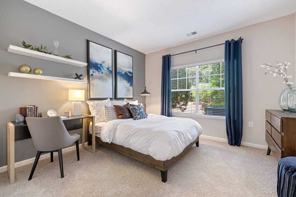 a bedroom with a bed , desk , chair and window at The Preserve at Ballantyne Commons in Charlotte, NC.