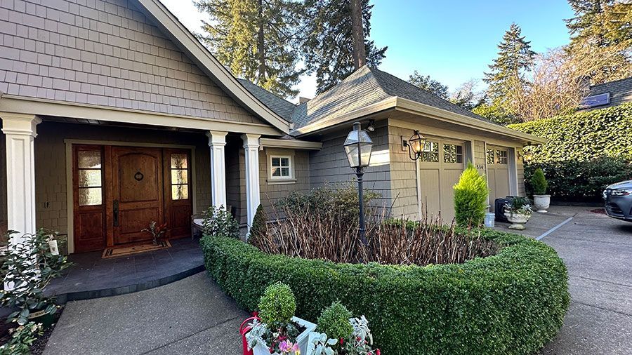 The front of a house with a car parked in front of it.