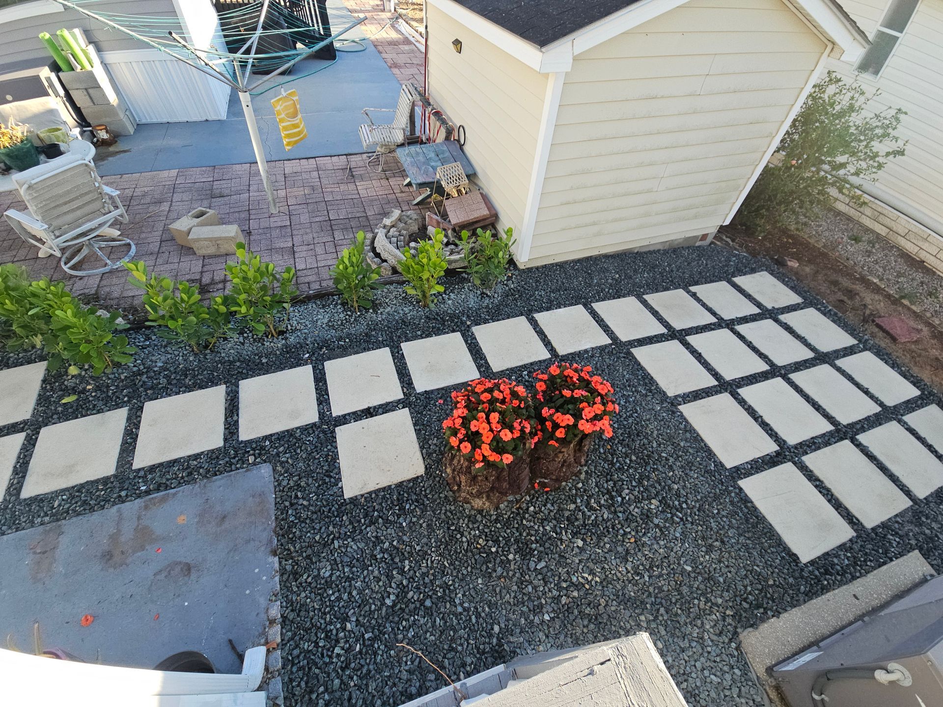A house with a lush green lawn and a driveway in front of it.