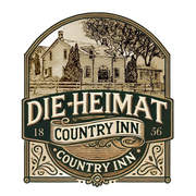 Logo for Die Heimat Country Inn, featuring a sketch of a historic building with the text "1856" in a decorative frame.