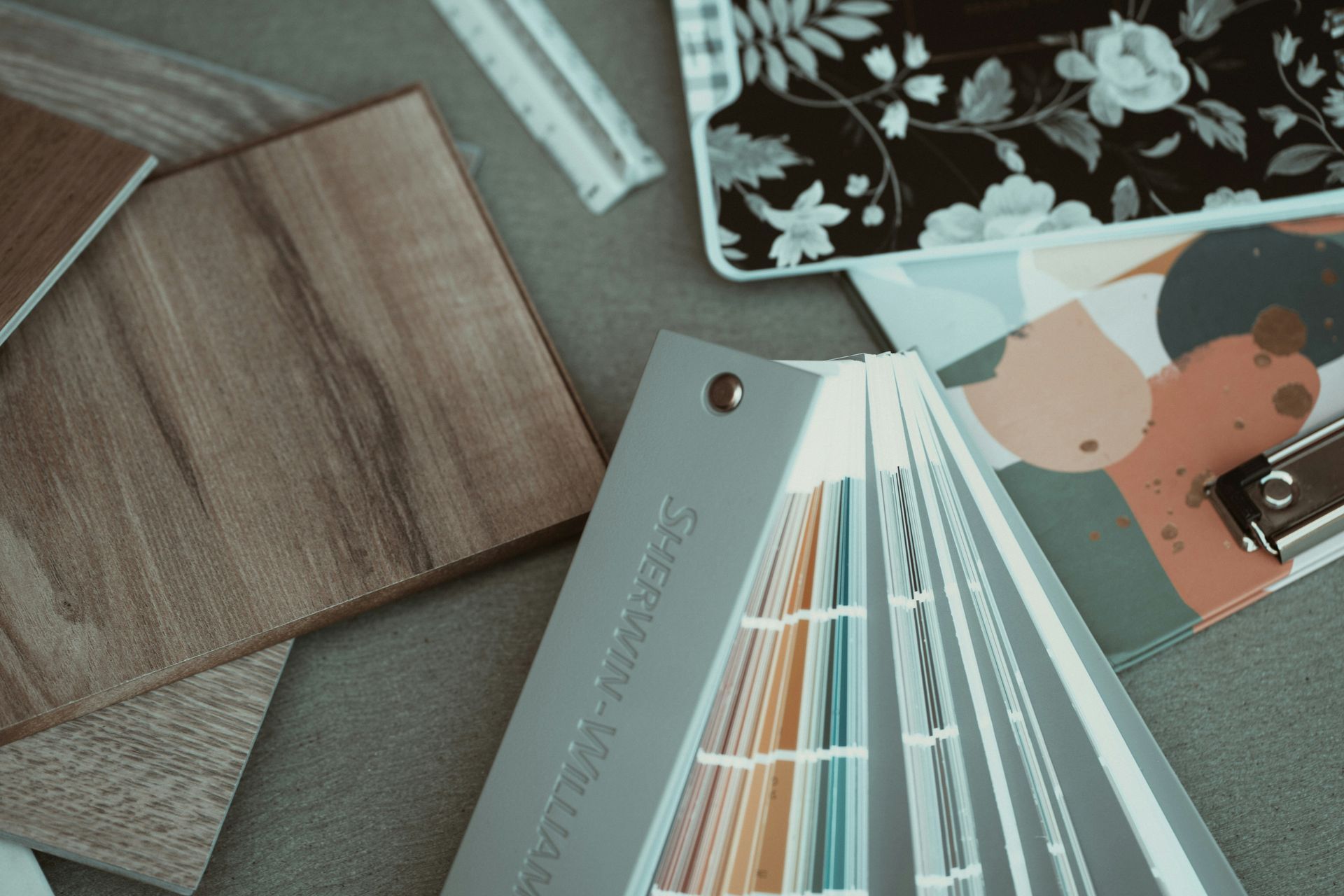 Paint swatches, wood samples, and design boards for interior home color and materials.