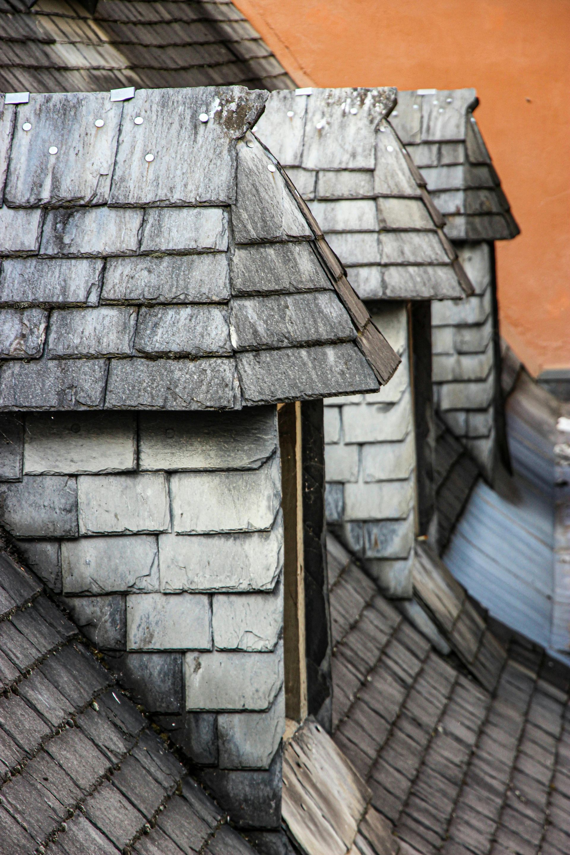Pennsylvania slate roof installation showing natural slate tiles and stone chimney