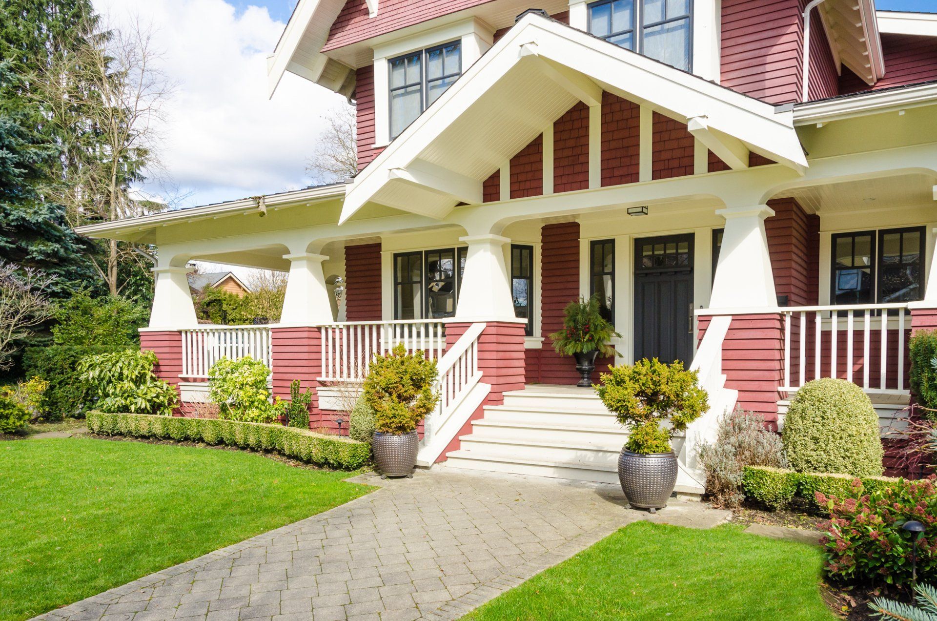 A large red and white house with a large porch.