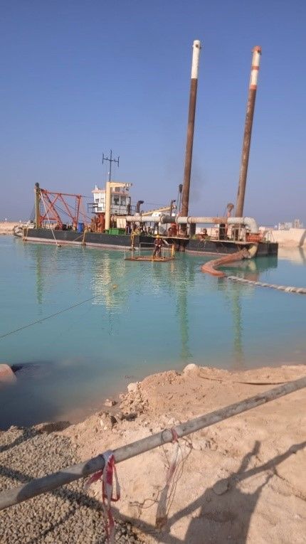 a large boat is floating on top of a body of water .