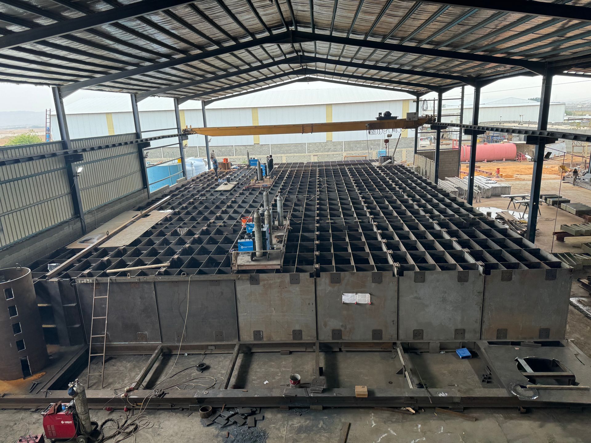 a large metal structure is being built inside of a building