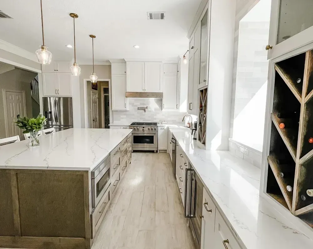 A kitchen with a large island and a wine rack.