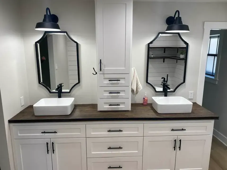 A bathroom with two sinks and two mirrors.