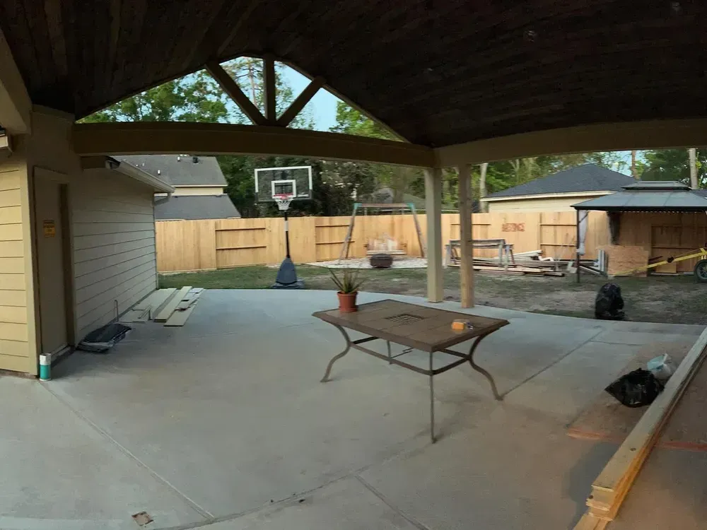 A patio with a table and a basketball hoop