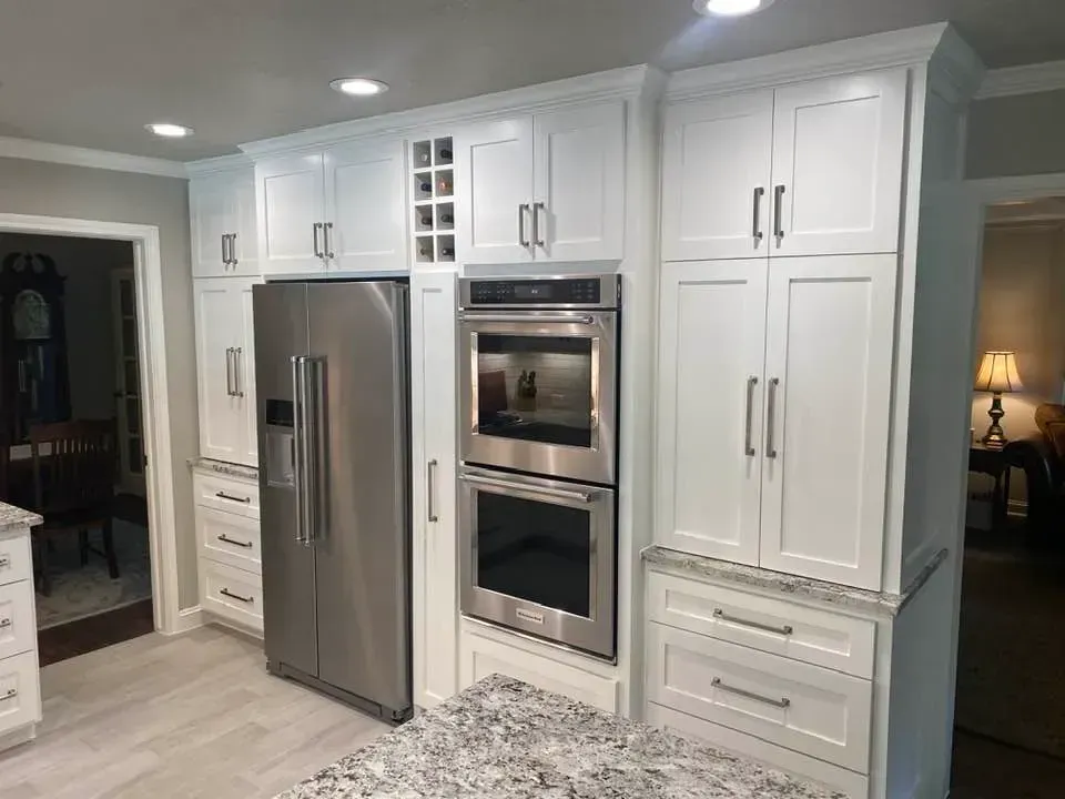 A kitchen with white cabinets and stainless steel appliances.