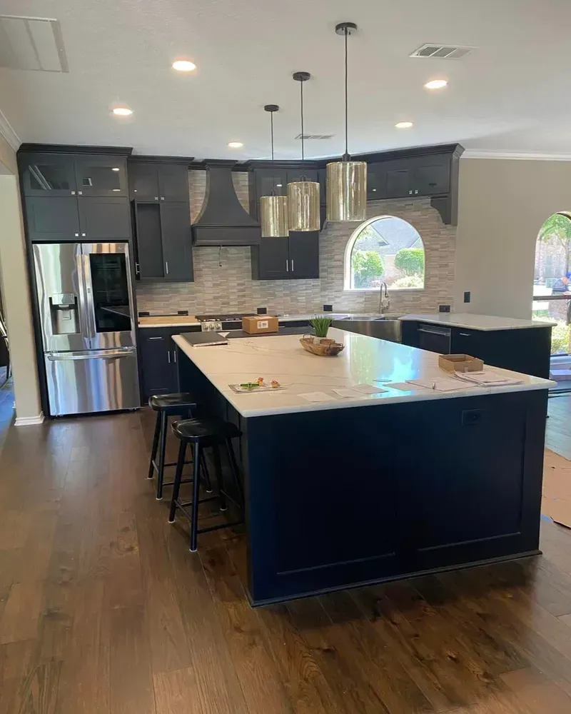A kitchen with a large island and stainless steel appliances.
