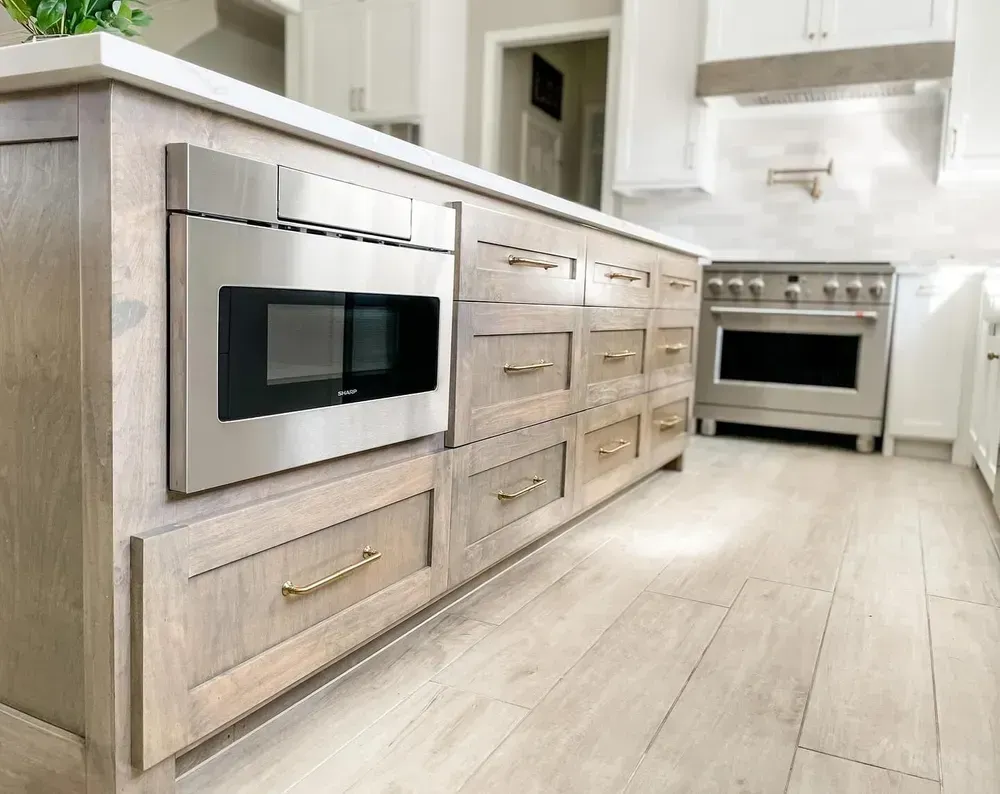 A kitchen with stainless steel appliances and wooden cabinets.