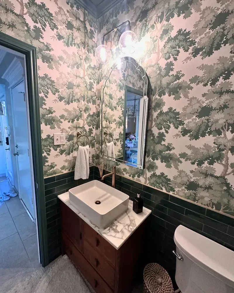 A bathroom with a sink , toilet and mirror.
