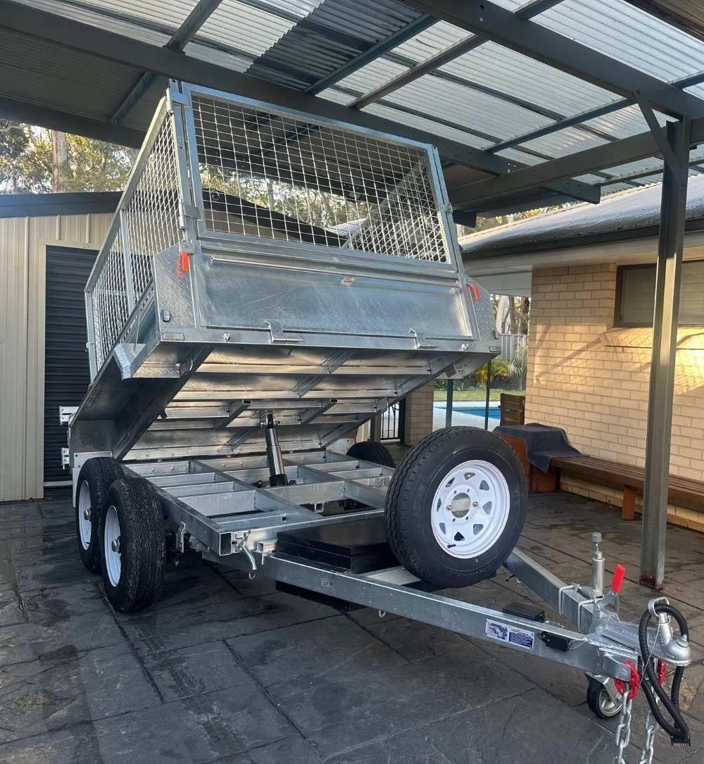 A Trailer is Parked Under a Canopy in Front of a House — Garrett's Excavation & Equipment Hire in Sanctuary Point, NSW