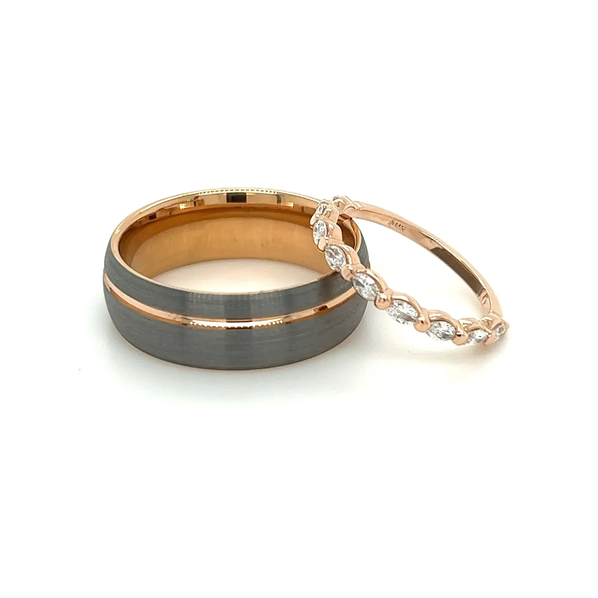 A couple of wedding rings on a white surface
