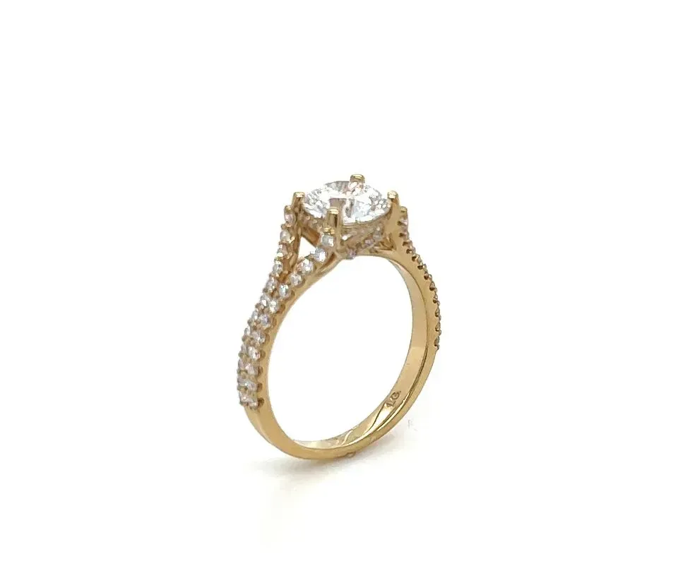 A yellow gold ring with a diamond in the center