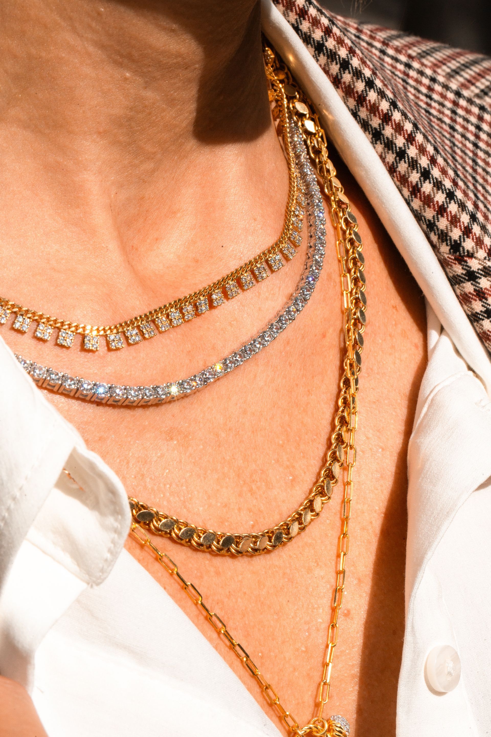 A close up of a person wearing a necklace