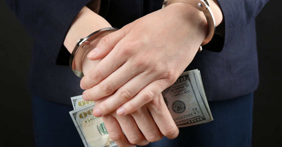 Handcuffed person with cash