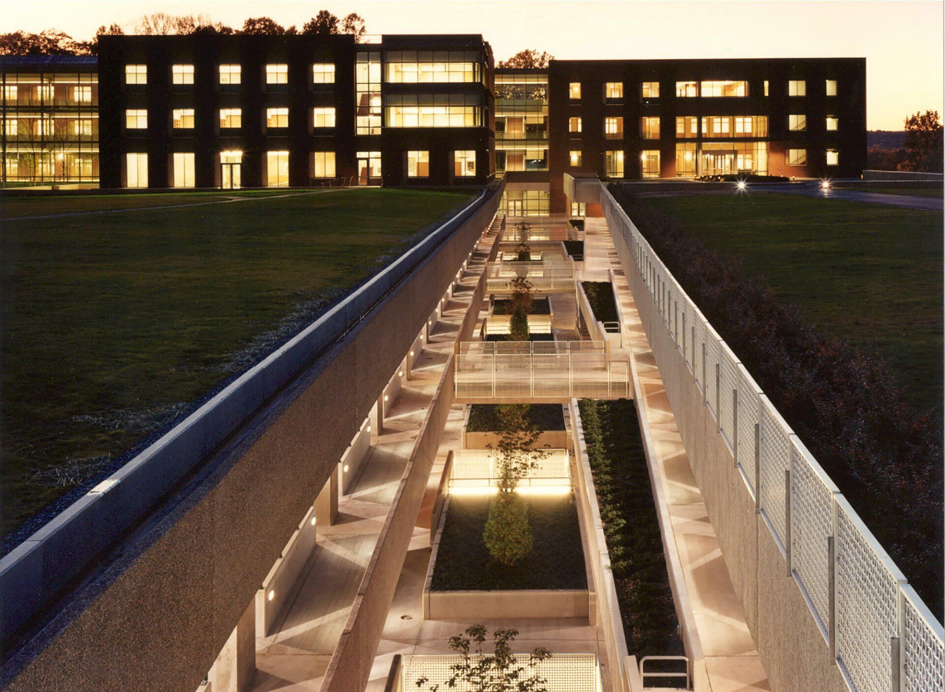 a large building with a lot of windows is lit up at night